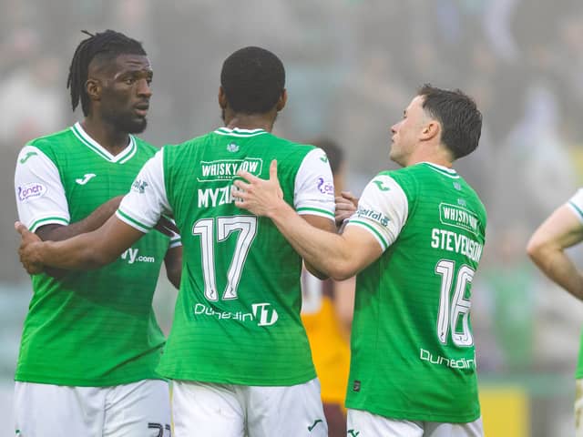 Nah, we aren't letting you go ... Myziane Maolida is embraced by Rocky Bushiri and Lewis Stevenson after scoring one of his 11 goals for Hibs.